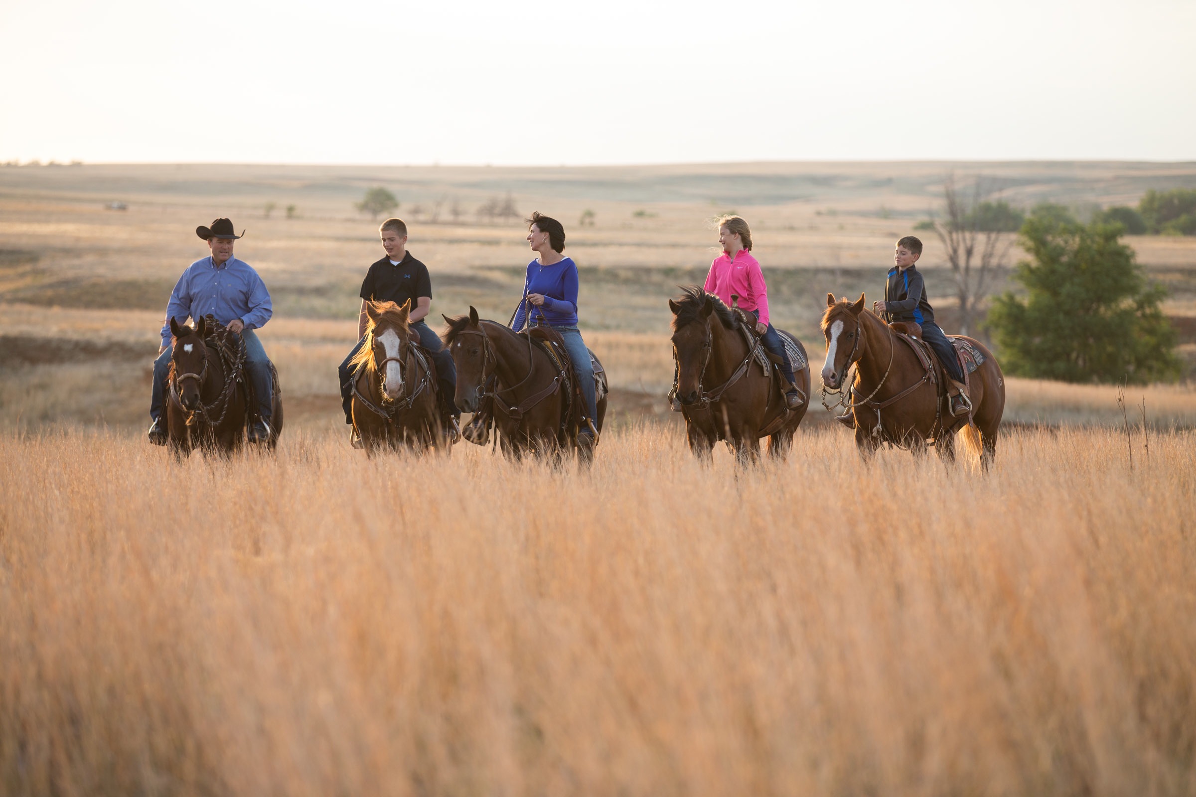 Horses are all in the family at Gardiner Quarter Horses as Garth, Greysen, Amanda, Grace and Gage ride across their ranch near Ashland. (Photo by Lori Adamski-Peek.)