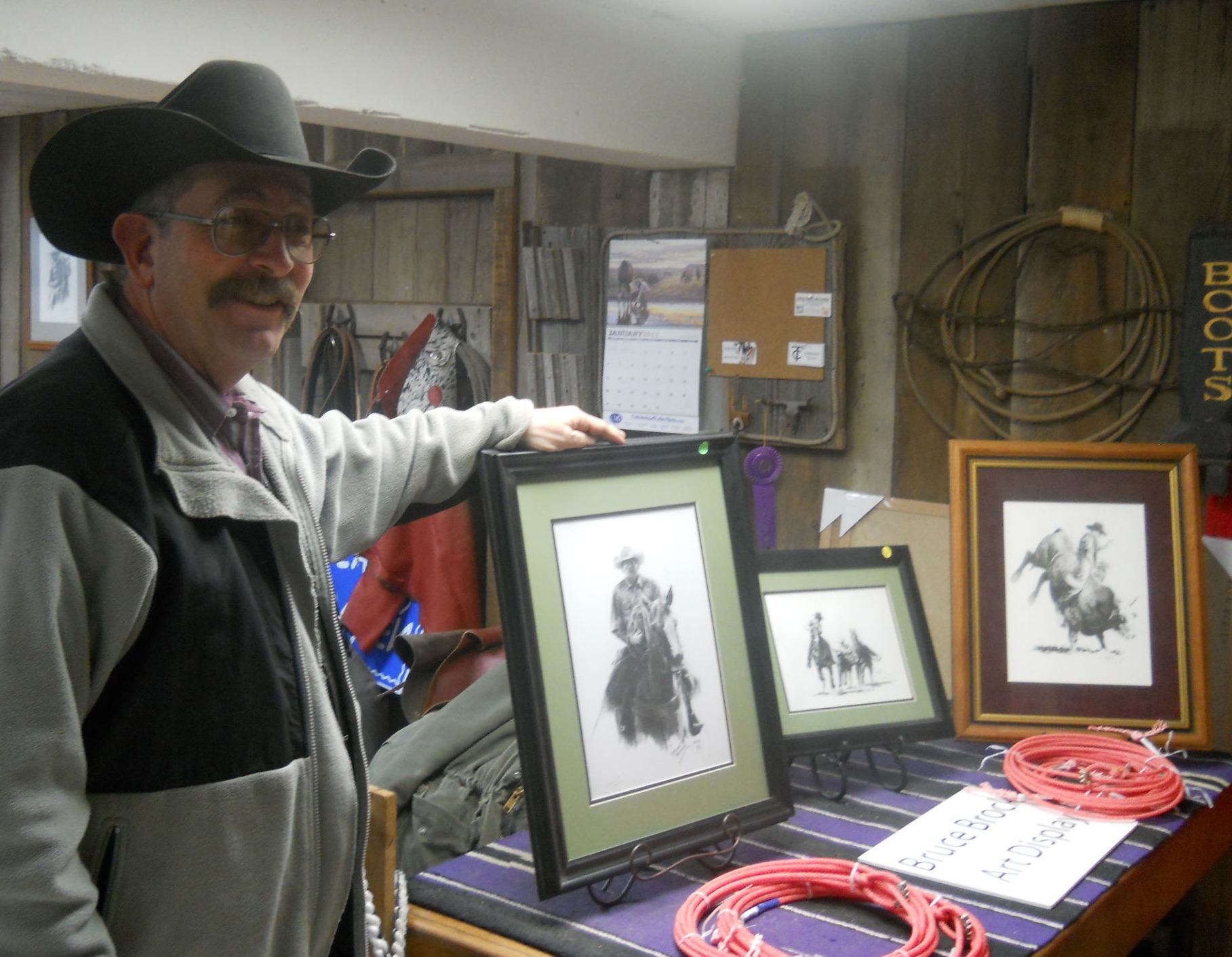 Leather craftsman-cowboy Bruce Brock is an artist, too, as verified by these elaborate pen-and-ink sketches, among the many diverse drawings and paintings he’s done and has displayed in the lower level of Jim Bell and Son, Cottonwood Falls.