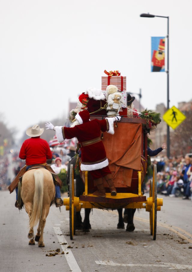 Santa Claus waved from back of the Dunn’s Landing stagecoach packed heavy with Christmas gifts as a climax ending of the 20th Lawrence Old-Fashioned Christmas Parade.