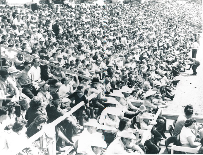 “No room to breathe,” somebody said, but there were no complaints as the action made all eyes peeled to the arena floor, as demanded  “peanuts, popcorn, and pop,” kept the callers-peddlers more than busy with refills during this Sunday afternoon performance of the Flint Hills Rodeo in 1963. Evening shows for the 78th edition of the professional Western action is set for the same renowned Strong City arena June 4-5-6.