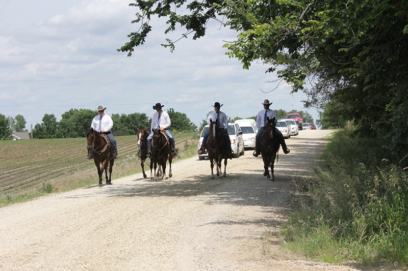 Grandsons Drew James, Jamie Stover, Brady James and Alex James lead Bill James rider less horse ahead of the hearse into St. Joseph Cemetery, Abilene, for James’ graveside services.