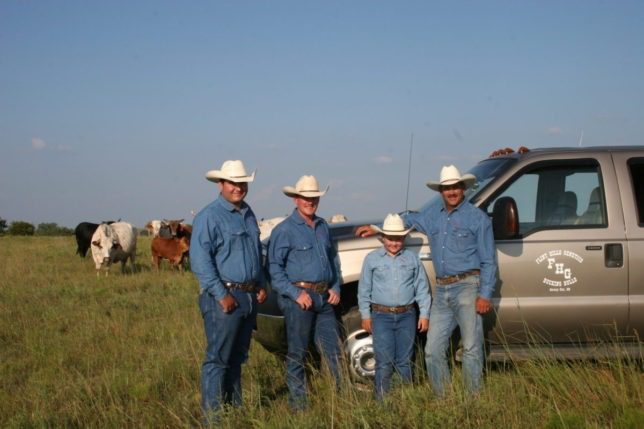 With their herd of registered seed stock in the background, Adam Spain, Kyle Gibb, Wyatt Reyer and Kim Reyer are in a partnership bull production business called Flint Hills Genetics at Strong City. The family business is co-sponsoring the sixth annual Flint Hills Bull Blowout bull riding competition Saturday evening, Sept. 12, at Strong City, and will have a number of bulls raised by their operation in the evening’s performance.