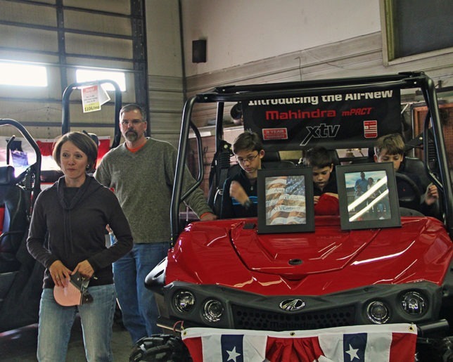 Winner Army Lt. Col. Candy Smith, her husband retired Lt. Col. Steve Smith and their three sons, Sam, Dillon and Finn, of Platte City, Missouri, were a happy family after receiving keys to a new Mahindra XTV awarded at Heinen Repair Service, Valley Falls, as climax to the Mahindra Tribute To The Brave Giveaway. (Photo courtesy of Lizzie Esparza, LE Photography.)