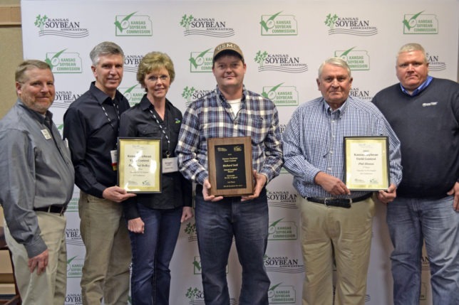 Center, Richard Seck, Reno County, had the highest yielding soybeans in the state with 96.49 bushels per acre as recognized also as the irrigated-no-till winner at the Kansas Soybean Expo, where Raylen Phelon, Melvern, president of the Kansas Soybean Association, presented awards. Raymond DeBey, Osborn County, second from left was second in irrigated-no-till competition, and third went to Phil Hinton, Brown County, second from right. (Photo from the Kansas Soybean Commission.)