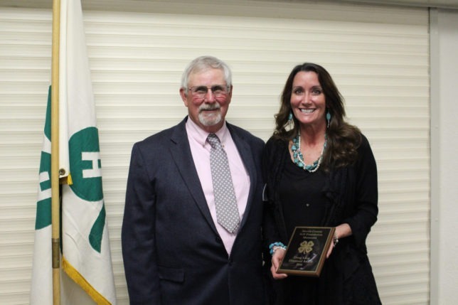 With Larry Johnson, president of the Morris County 4-H Foundation, Karen Laue accepted the Diamond Memorial for the Doug Laue Bequest during the annual banquet Friday evening. (Photo by Chelsea Richmond.)