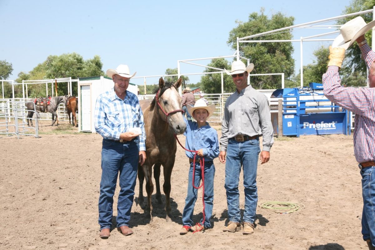 Four Chex Figure, best known as Patch, won the 2014 Haythorn Ranch Futurity at Arthur, Nebraska, for owner Dr. Tom Jensen, and his wife Jan, of Blue Mound. Adrian Vogel of Cottonwood Falls rode the champion, and Vogel’s son Pax joined in the winner’s picture.
